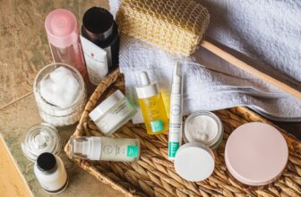 A serene bathroom counter with skincare products neatly arranged, including cleansers, moisturizers, and serums, surrounded by natural elements like plants.