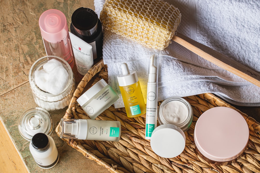 A serene bathroom counter with skincare products neatly arranged, including cleansers, moisturizers, and serums, surrounded by natural elements like plants.