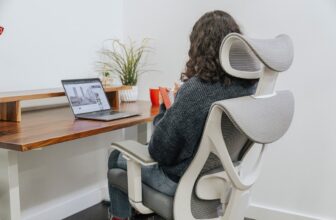 An ergonomic office chair with proper lumbar support in a modern workspace setting.