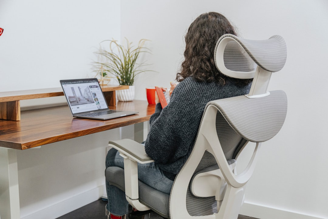 An ergonomic office chair with proper lumbar support in a modern workspace setting.