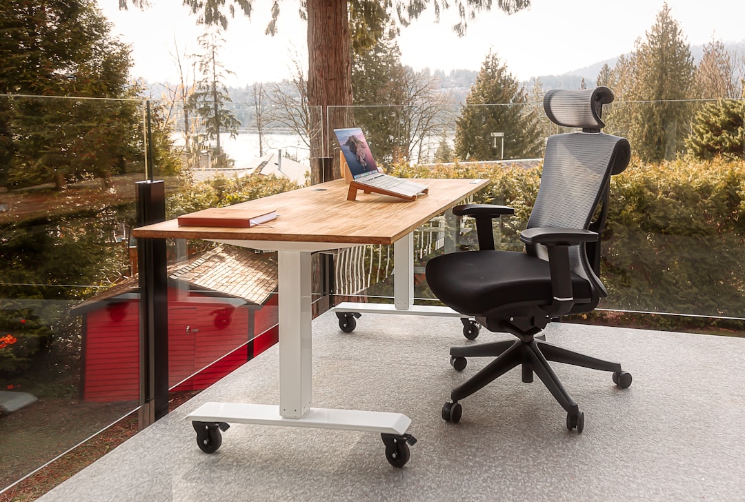 A comfortable home office setup with ergonomic chair and desk, showcasing proper posture to reduce neck and shoulder pain.